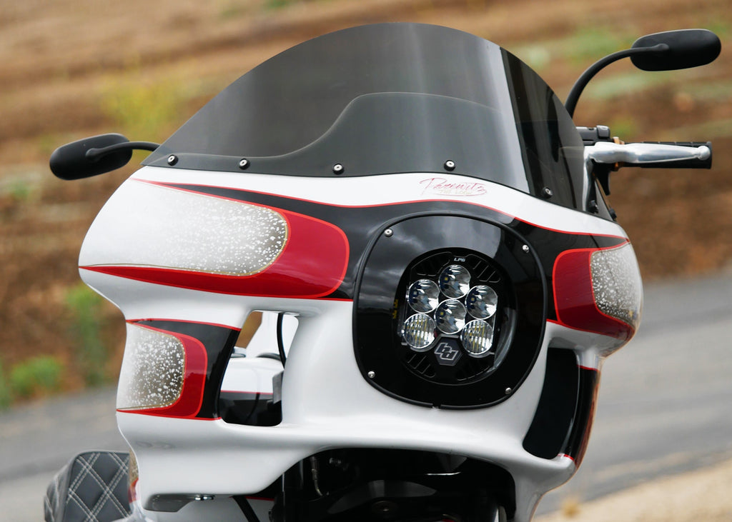LP6 headlight installed on a custom Harley parked in front of a dirt landscape