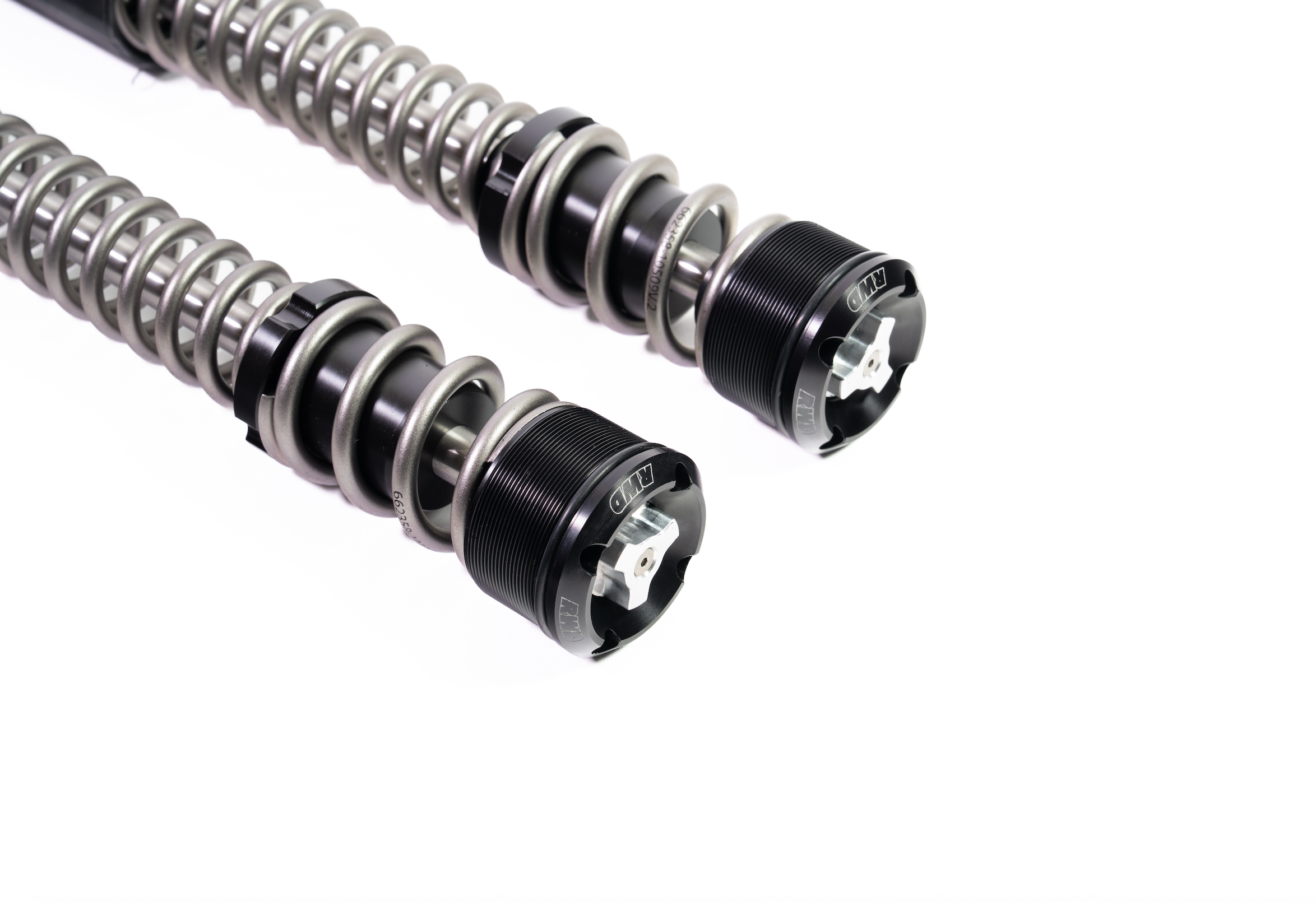 Two RWD V-Twin motorcycle fork springs with black caps and silver adjustment knobs, set against a white background.