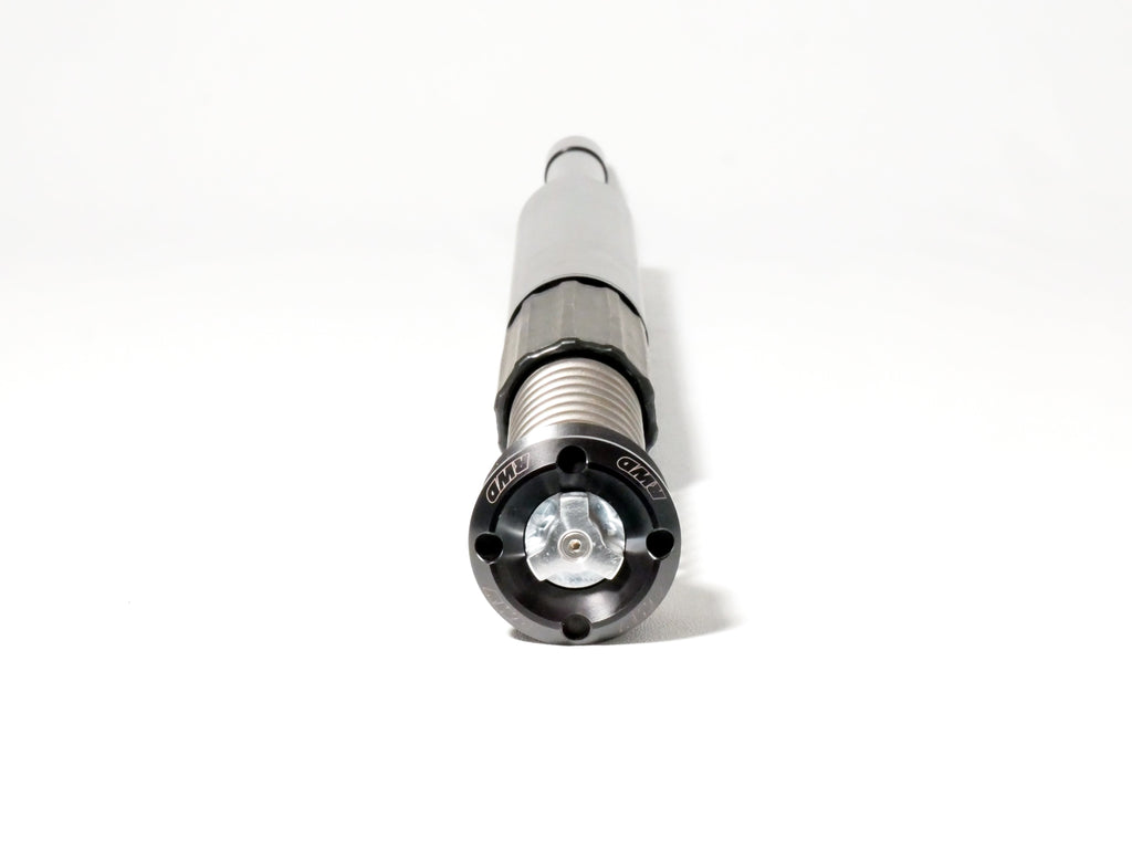 A close-up, eye-level shot of an RWD V-Twin RS-1F front fork cartridge, showcasing its black anodized cap with the RWD logo, silver spring, and gray body against a clean white background.